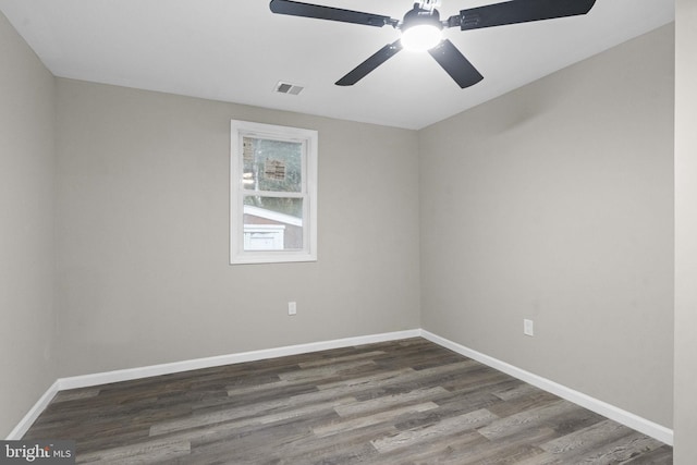spare room featuring dark hardwood / wood-style flooring and ceiling fan