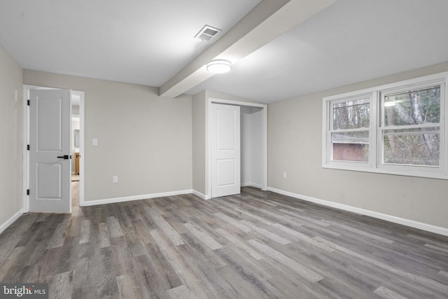 unfurnished bedroom featuring wood-type flooring and a closet