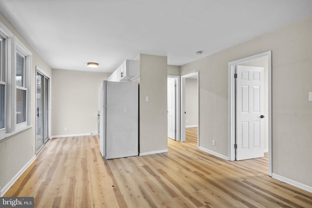 unfurnished room with light wood-type flooring