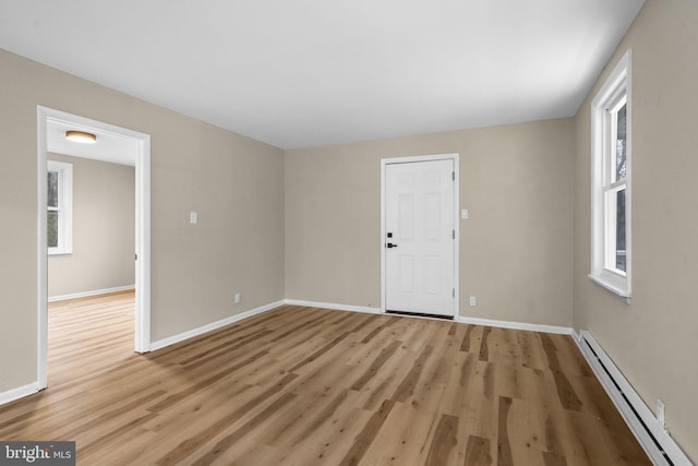 spare room with light hardwood / wood-style floors and baseboard heating