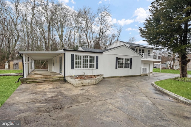 view of front of house with a carport and a balcony