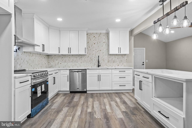 kitchen with stainless steel appliances, light stone countertops, wall chimney range hood, and white cabinets