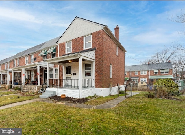 view of front of property featuring covered porch and a front lawn