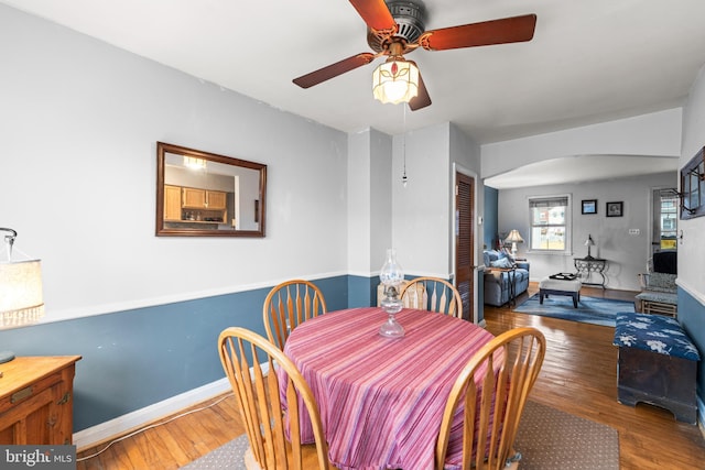 dining area featuring wood-type flooring and ceiling fan