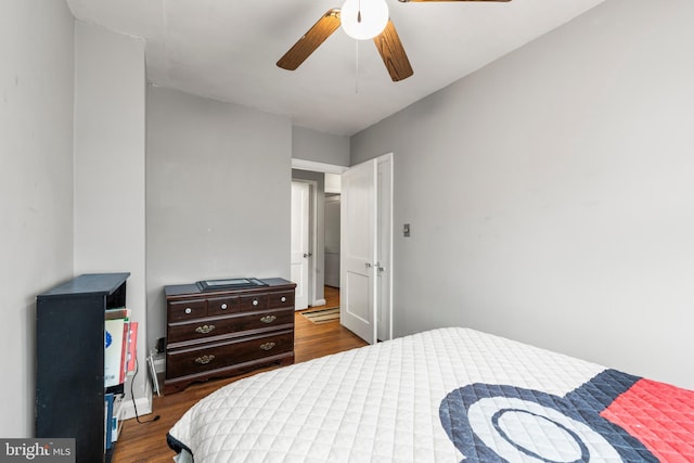 bedroom featuring ceiling fan and dark hardwood / wood-style flooring