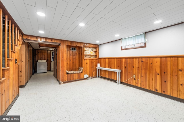 basement featuring washer / clothes dryer and wood walls