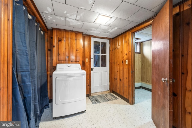 washroom featuring wooden walls and washer / clothes dryer