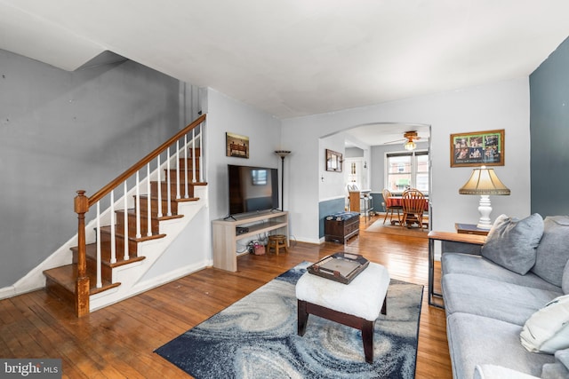 living room featuring ceiling fan and wood-type flooring