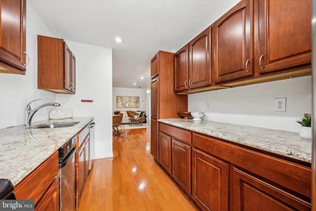 kitchen with dishwasher, light stone countertops, sink, and light hardwood / wood-style flooring