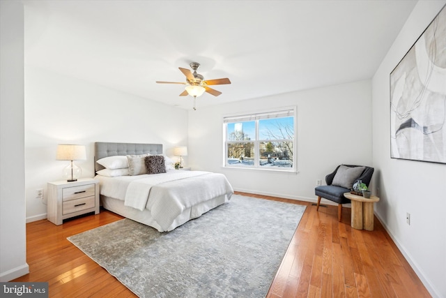 bedroom with ceiling fan and light hardwood / wood-style floors