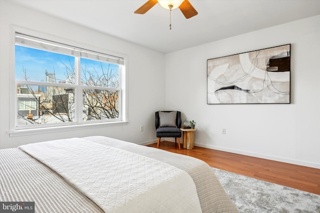 bedroom featuring hardwood / wood-style flooring and ceiling fan