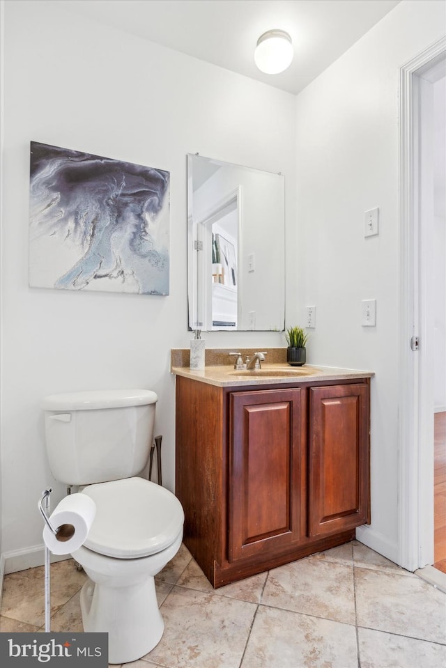 bathroom featuring tile patterned flooring, vanity, and toilet