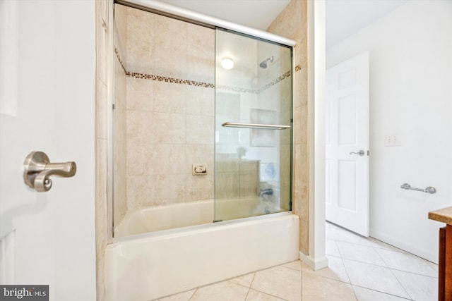 bathroom with shower / bath combination with glass door and tile patterned flooring