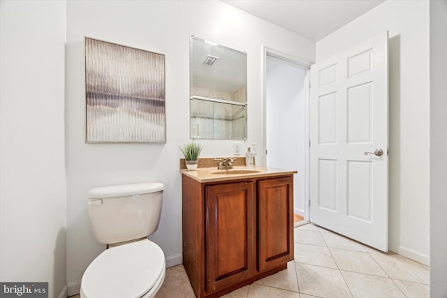 bathroom with vanity, toilet, a shower with door, and tile patterned flooring