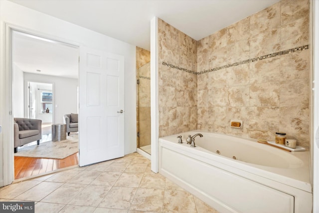 bathroom featuring tile walls, tile patterned floors, and separate shower and tub