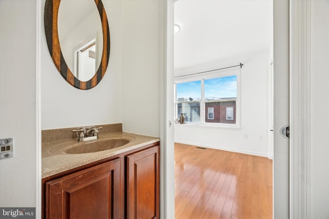 bathroom with hardwood / wood-style flooring and vanity