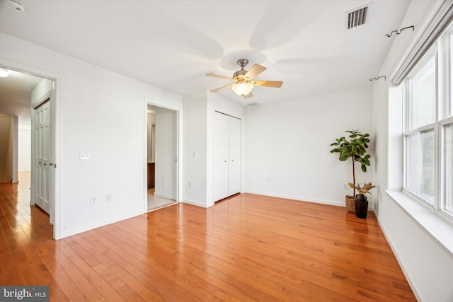 unfurnished room with ceiling fan and light hardwood / wood-style floors