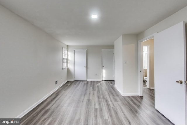 spare room with light hardwood / wood-style flooring