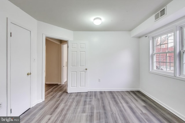 spare room featuring light hardwood / wood-style flooring