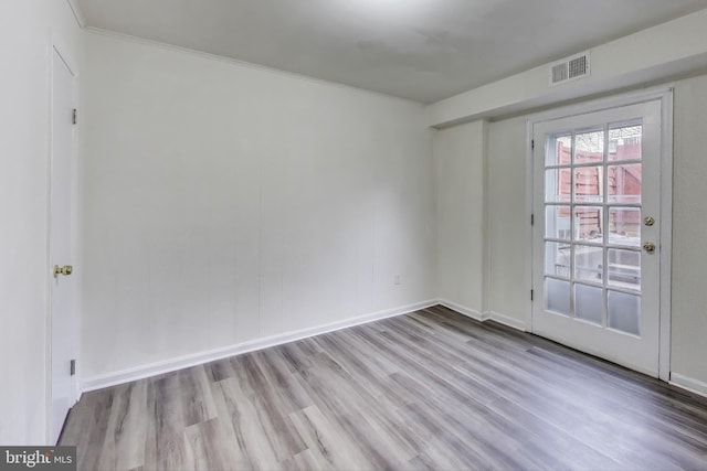 empty room with light hardwood / wood-style flooring