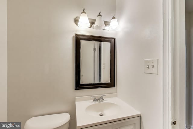 bathroom featuring vanity and toilet