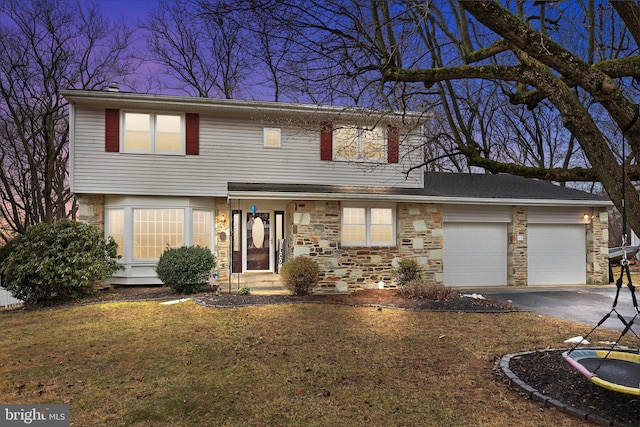 front facade featuring a garage and a front yard