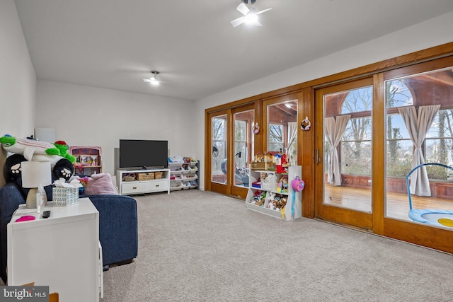 recreation room featuring light colored carpet