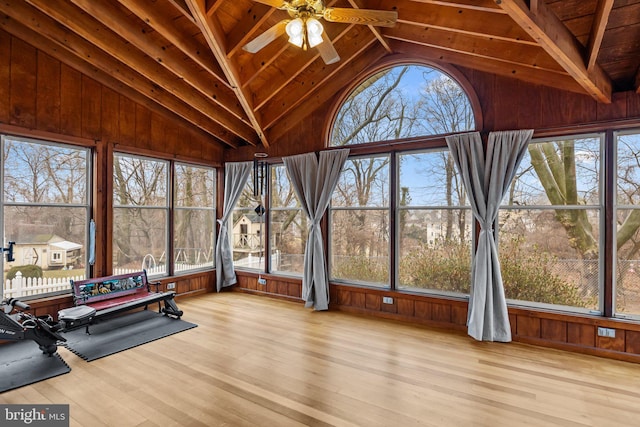 sunroom / solarium with vaulted ceiling with beams, wood ceiling, and ceiling fan