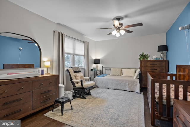 bedroom featuring dark hardwood / wood-style floors and ceiling fan