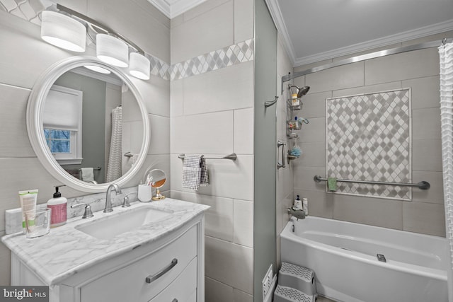 bathroom featuring crown molding, vanity, and tiled shower / bath