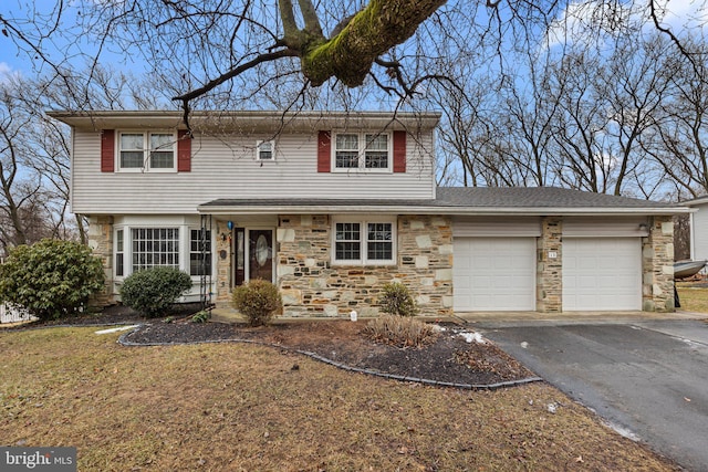 view of front of home with a garage and a front lawn