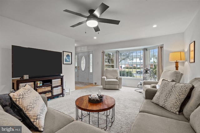 living room with light colored carpet and ceiling fan