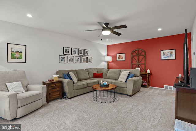 living room featuring light carpet and ceiling fan