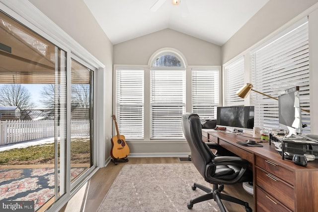 office area featuring lofted ceiling, ceiling fan, and light wood-type flooring