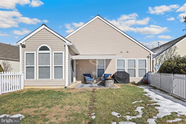 back of house featuring a patio and a lawn