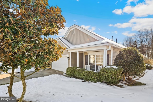 view of snowy exterior with a garage