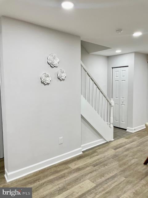 staircase featuring wood-type flooring