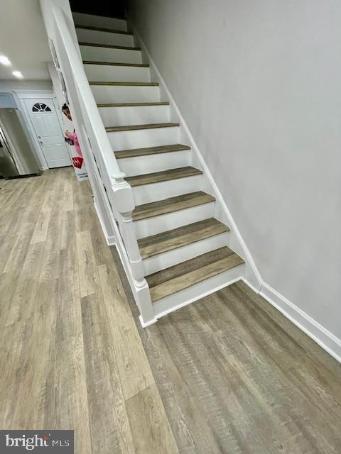 staircase featuring hardwood / wood-style flooring