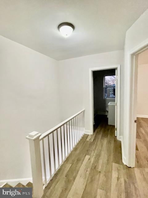 corridor with light hardwood / wood-style floors