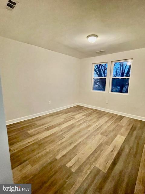 empty room with hardwood / wood-style floors