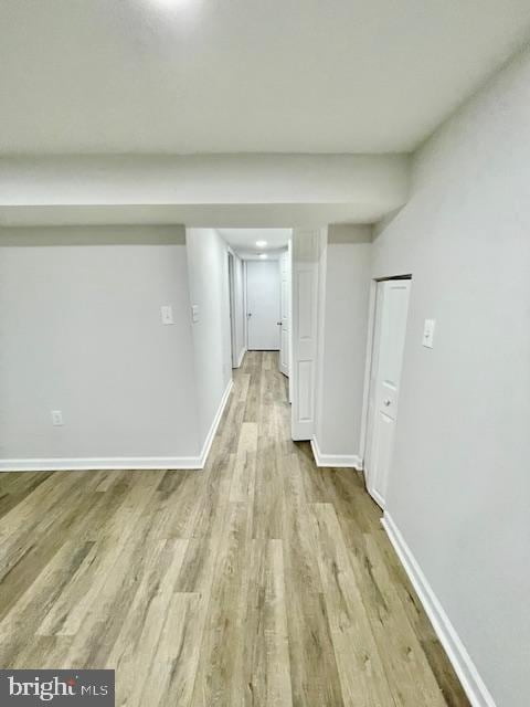 hallway with light hardwood / wood-style floors