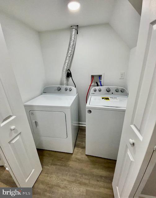 laundry area featuring independent washer and dryer and hardwood / wood-style floors