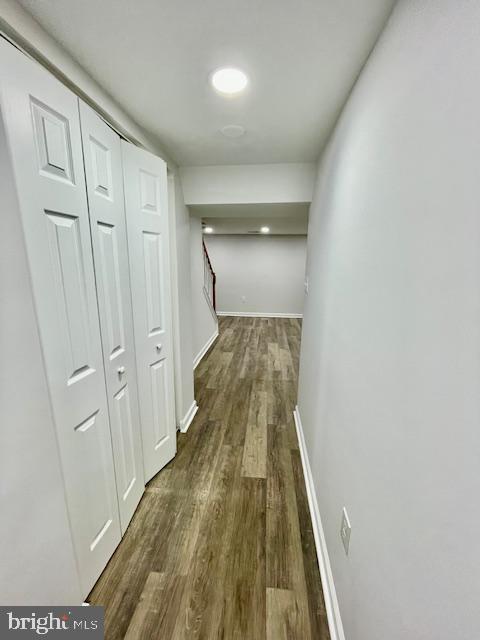 hallway with dark wood-type flooring