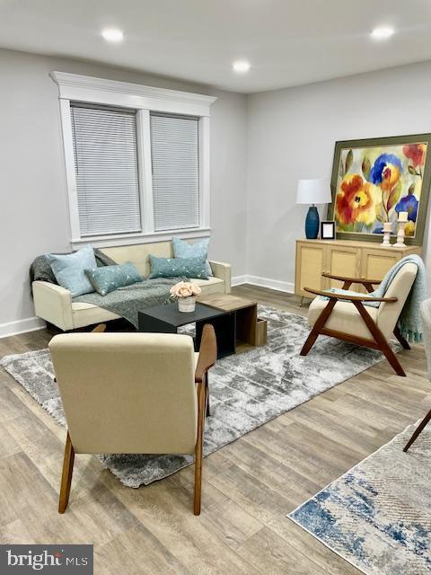 sitting room with wood-type flooring