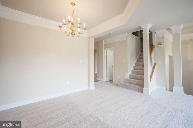 carpeted empty room with a tray ceiling, crown molding, and a chandelier