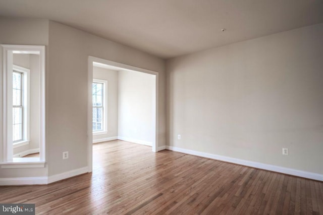 empty room featuring hardwood / wood-style flooring and a healthy amount of sunlight