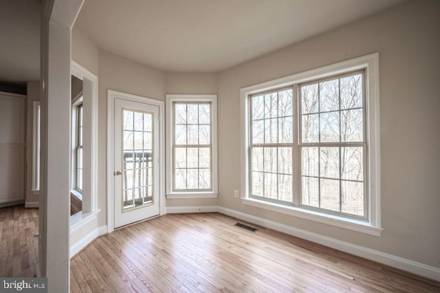 unfurnished dining area featuring light hardwood / wood-style flooring