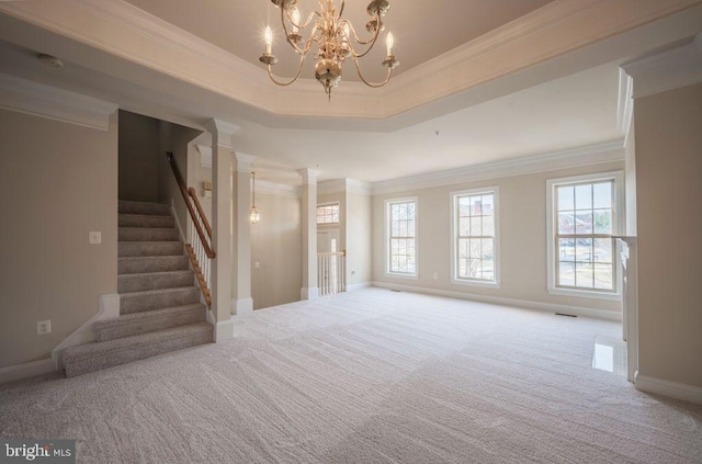 unfurnished living room with ornamental molding, plenty of natural light, and light carpet