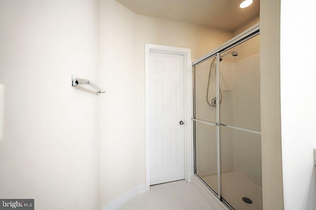 bathroom featuring a shower with door