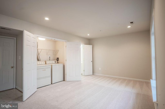 laundry room featuring light carpet and washing machine and dryer